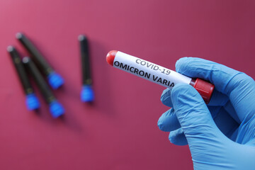  hand hold omicron variant corona virus blood test tube 