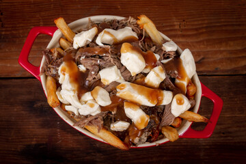 duck confit poutine dish on wood table