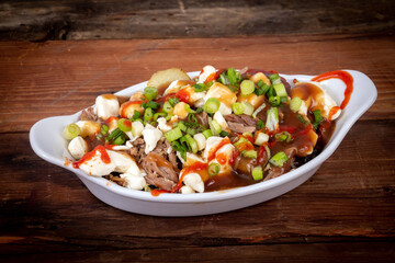 duck confit poutine dish on wood table