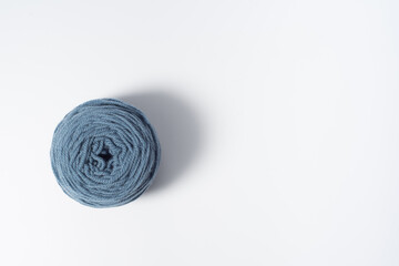 Large light blue ball of yarn on white background