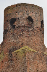 Castle ruins in Koło. Destroyed towers and defensive walls made of red brick on the bank of the...