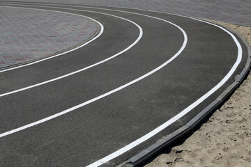 Asphalt racetrack on a stadium, abstract sports background