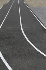 Fototapeta premium Asphalt racetrack on a stadium, abstract sports background