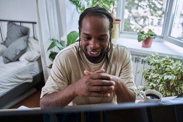 Handsome young man working with laptop at home