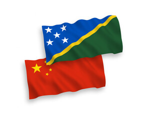 National vector fabric wave flags of Solomon Islands and China isolated on white background 1 to 2 proportion.