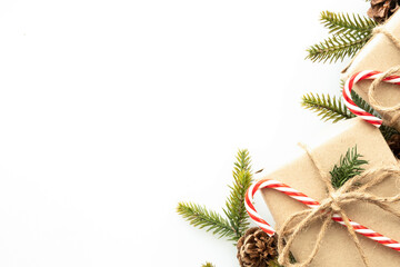 Beautiful Christmas background with gift boxes, decorate with pine branch and pine cone over white...
