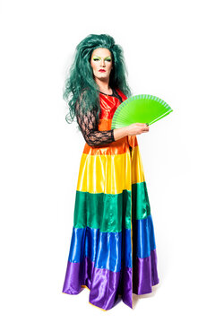 Man dressed wearing dress and wig holding fan over white background