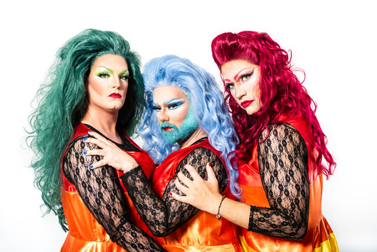 Drag queens with multi colored dress and wig against white background