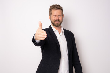Young happy caucasian businessman smiling while giving handshake