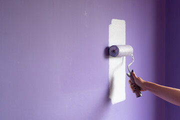 Painting at home with hand roller and copy space