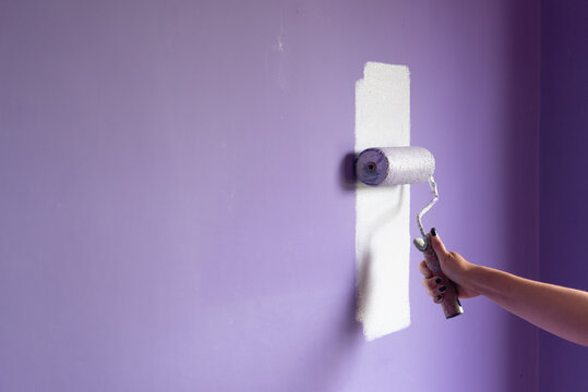 Painting at home with hand roller and copy space