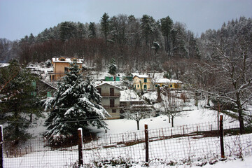 rural landscape in the hills among firs and pines in the Apuan mountains covered with winter white snow