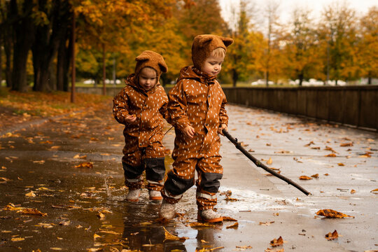 Twins with matching outfits playing on road