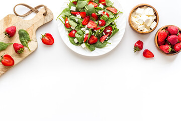 Vegetarian lunch spinach and strawberry salad. Top view