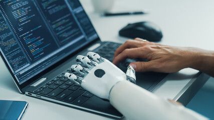 Close-up on Hands: Programmer With Disability Using Prosthetic Arm to Work on Laptop Computer. Specialist Swift and Natural Use of Myoelectric Bionic Hand To Type Code for Software - obrazy, fototapety, plakaty
