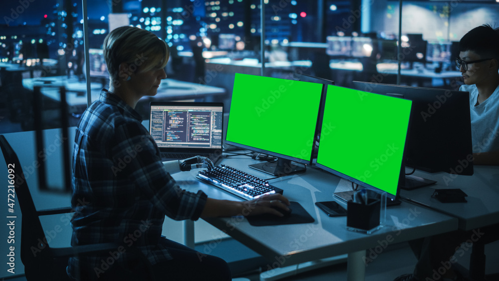 Poster Night Office: Person with Disability Using Prosthetic Arm to Work on Green Screen Chroma Key Computer. Swift and Natural Use of Myoelectric Bionic Hand To Type Code for Software at Night.