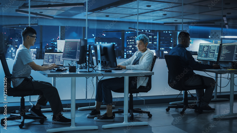 Fototapete Diverse Office at Night: Multi-Ethnic Team of Young Programmers Working on Desktop Computers, Screens Show Coding Language User Interface. Software Engineers Create Innovative e-Commerce App.