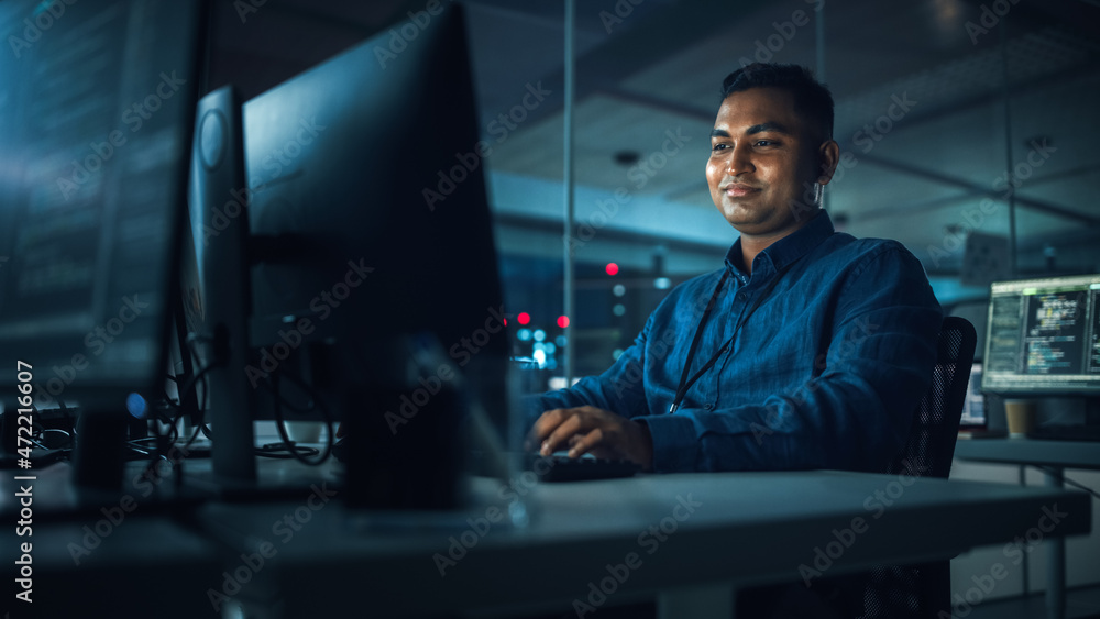 Poster Night Office: Portrait of Handsome Indian Man in Working on Desktop Computer. Digital Entrepreneur Typing, Creating Modern Software, e-Commerce App Design, Programming. Successful Smiling Man