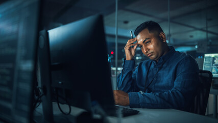 Night Office: Portrait of Handsome Indian Man in Working on Desktop Computer. Digital Entrepreneur...
