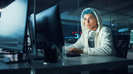 Late at Night in Office: Portrait of Young Stylish Freelancer Woman Working on Desktop Computer. Non-Binary Person Creating Modern Content, Do Contemporary Project Design, Create Colorful Marketing - obrazy, fototapety, plakaty