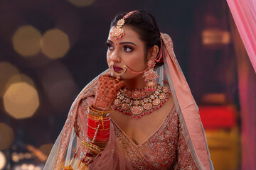 Portrait of a beautiful Indian bride in traditional wedding outfit