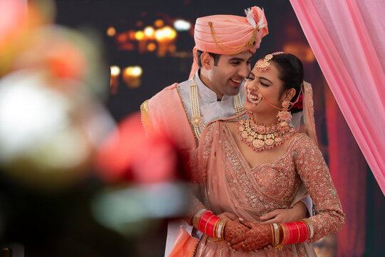 Portrait of an Indian wedding couple posing for album