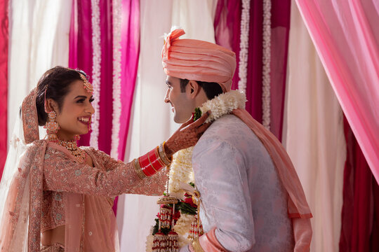 Couple performing Jaimala in mandap during their wedding