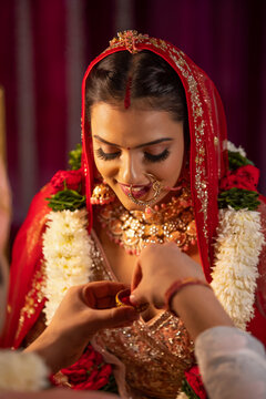 Couple performing Sindoor Daan ritual during their wedding