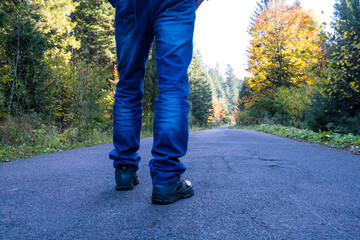 Man walking down on a forest road.
