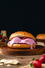 burger with strawberry ice cream.Ice cream sandwich on wood background. 