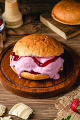 burger with strawberry ice cream.Ice cream sandwich on wood background. 