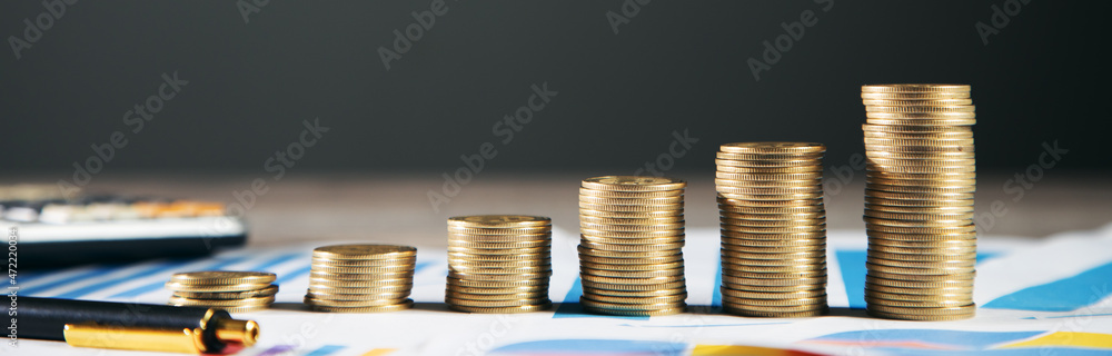 Poster calculator with stack of coins on graph paper
