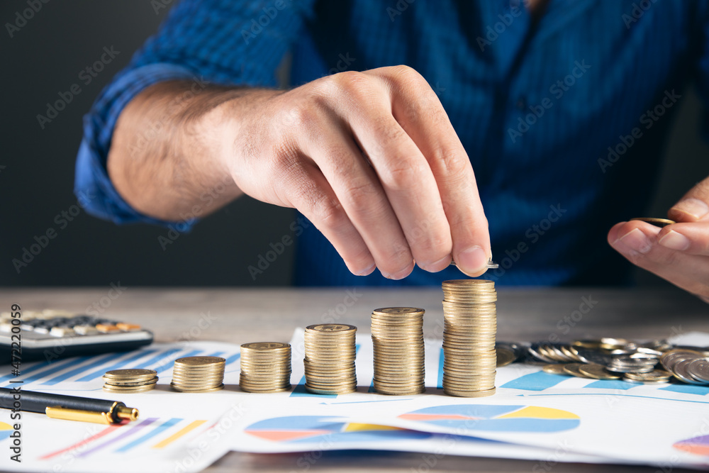 Poster man stacking coins with calculator