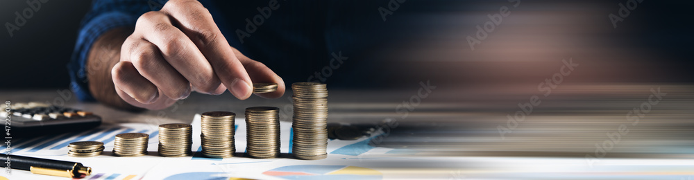 Poster man stacking coins with calculator