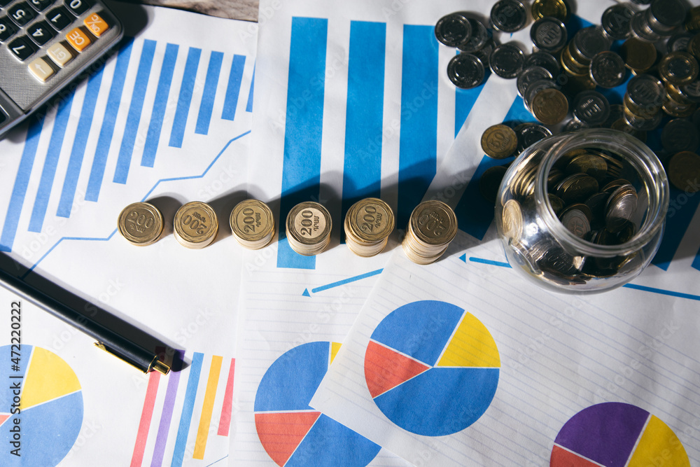 Aufkleber calculator with stack of coins on graph paper