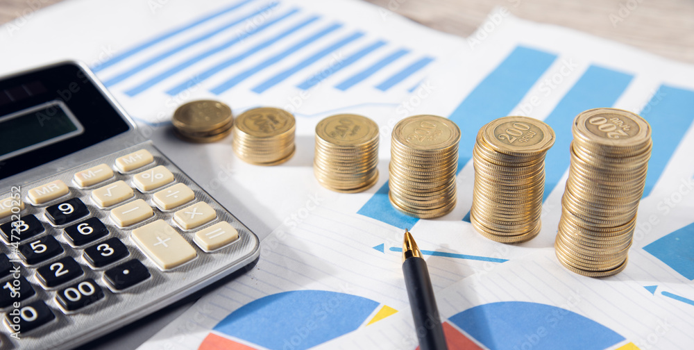 Aufkleber calculator with stack of coins on graph paper
