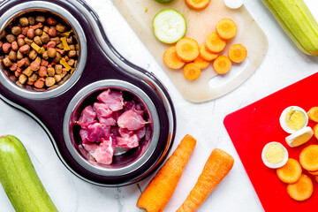 organic pets food with zucchini and carrot on table background top view