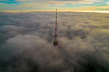 Obraz premium Aerial view of the television tower in the fog