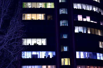 Obraz premium City at night. A high-rise building with luminous windows.