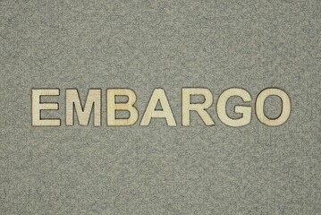 Fototapeta na wymiar text on word embargo from wooden letters on a gray background
