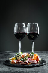 Appetizers with prosciutto and blue cheese. antipasti with red wine