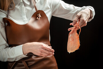 Dry Spanish ham, Jamon Serrano, Iberian ham cutter. Slicing Spanish jamon iberico. Spanish jamon...