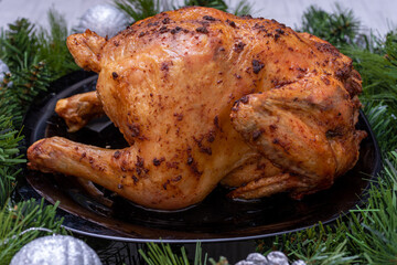 Traditional Christmas food. Fried chicken, turkey on a festive table with fir branches and Christmas tree decorations