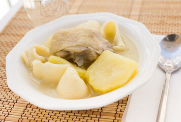 chicken broth soup with chicken, potatoes, and pasta shells