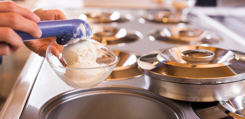 ice cream razor with ice cream ball in background of refrigerated display case