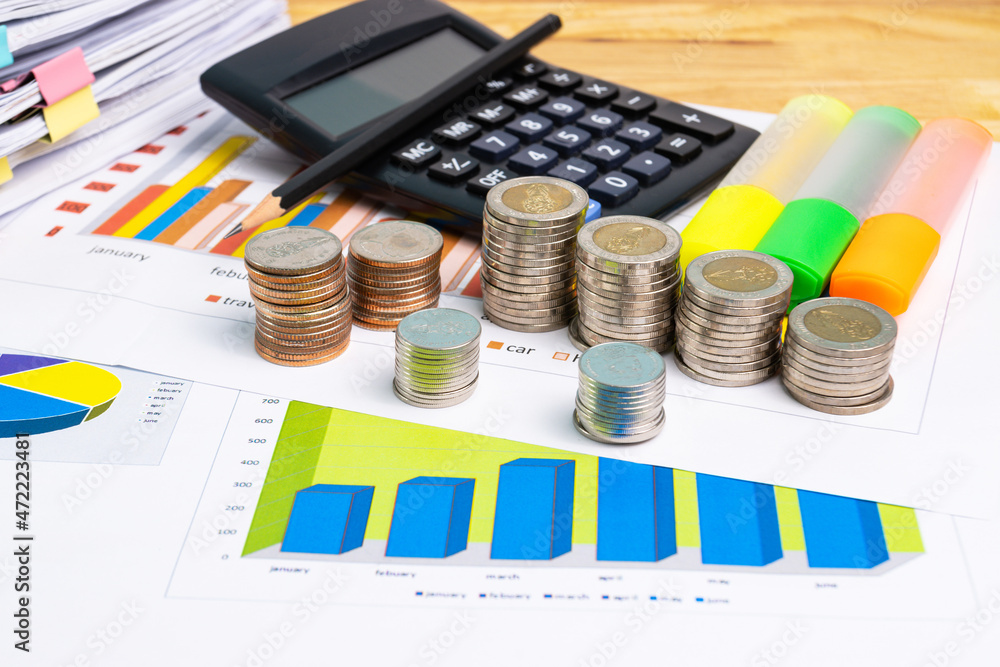 Poster the stack of coin with business paper graphs and pencil with charts report, calculator concept of ca