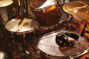 Black Headphones on Studio Drums. Beautiful Closeup Concept Recording Studio or Concert Hall Tools. Musical Background