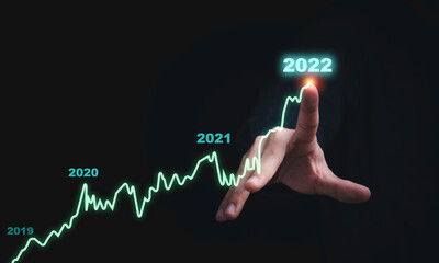 Businessman drawing virtual technical graph and chart for analysis stock market, technology investment and value investment concept.