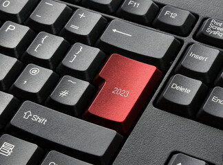 A Black Keyboard With Red 2023 Key
