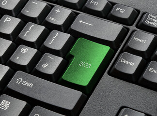 A Black Keyboard With green 2023 key